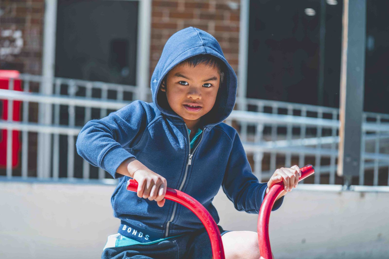 Student playing confidently on playground equipment outdoors